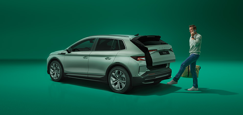 A green SUV on a dark green soundstage