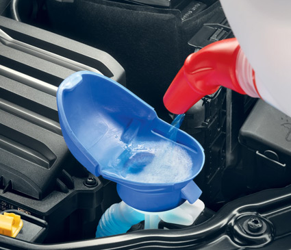 Engine washer fluid tank with a built-in funnel